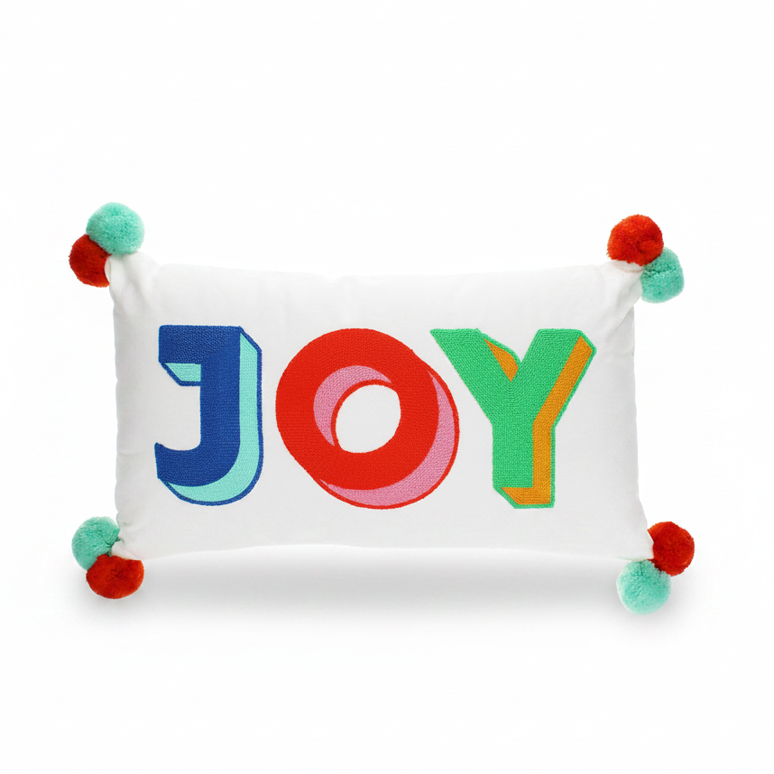 Joy embroidered pom pom cushion front view on grey background