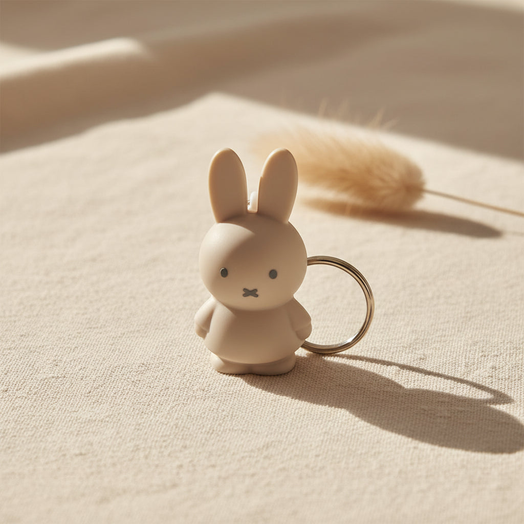 Moulded sand beige Miffy figure with a silver split ring, front view