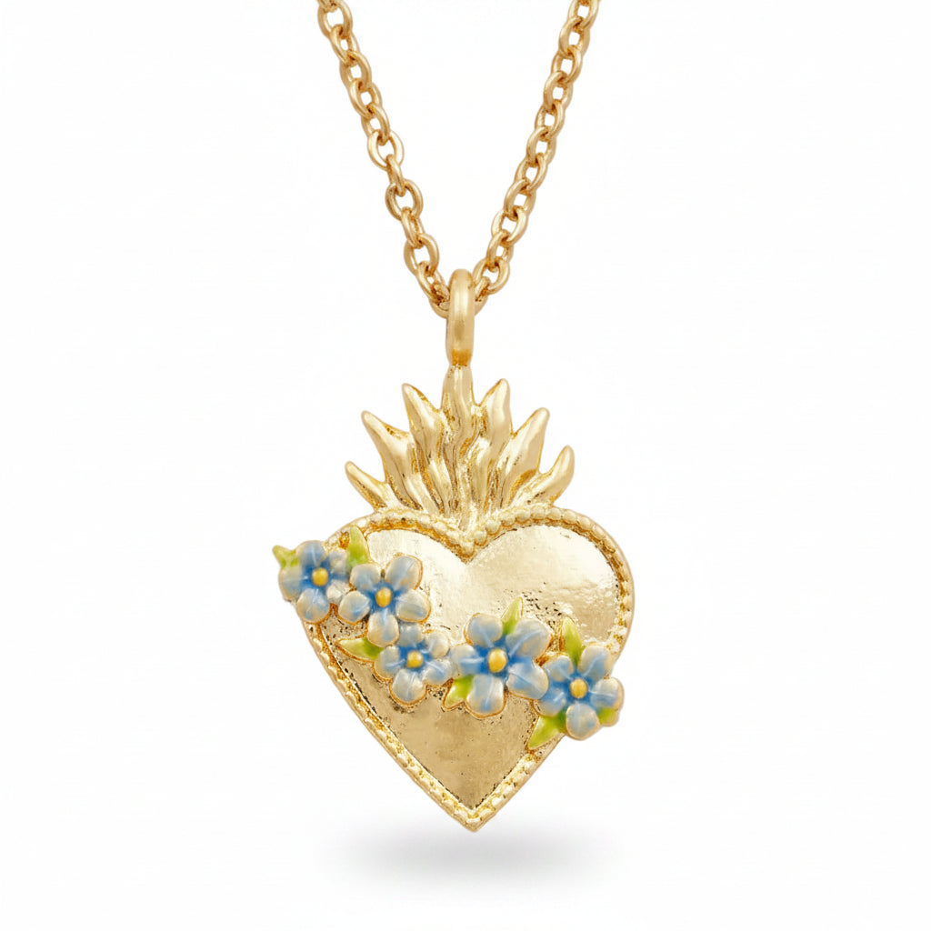 Gold sacred heart necklace with blue floral pendant on white background.