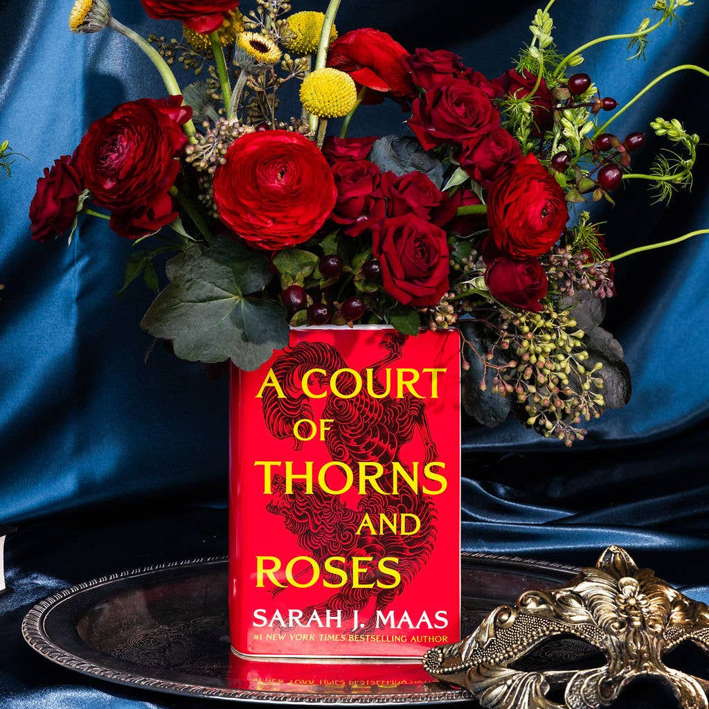 A Court of Thorns and Roses Book Vase with red roses on blue satin