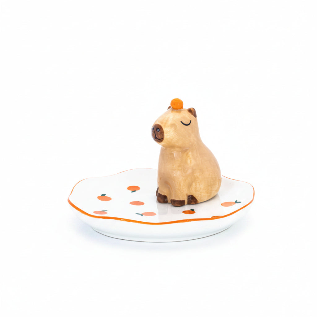 Capybara trinket dish with orange on head on white background front view
