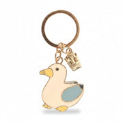 Close-up of Seagull and Chips keyring showing gold enamel seagull with blue wing and tiny chip charm on gold keyring.