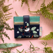 Secret Garden bird purse in navy faux leather on pink background