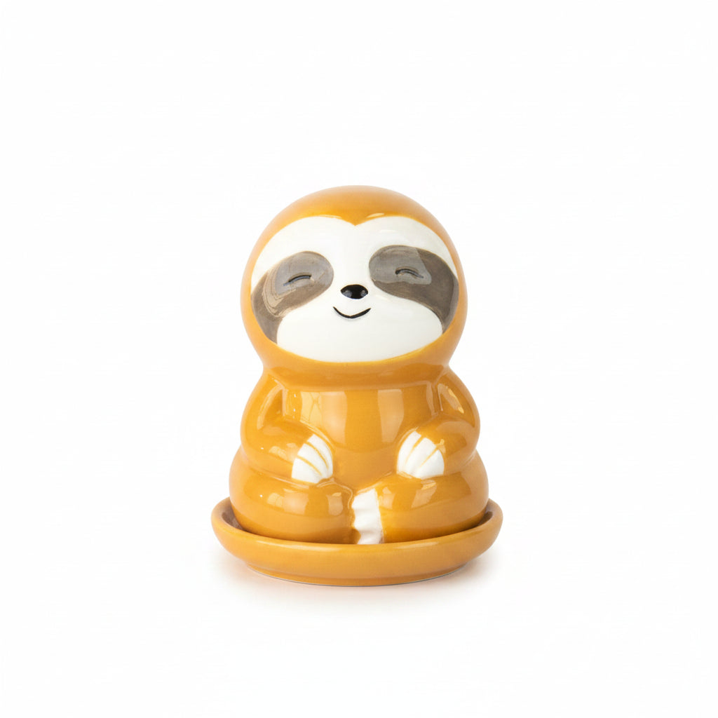 Orange sloth incense burner on tray with smoke and incense cones