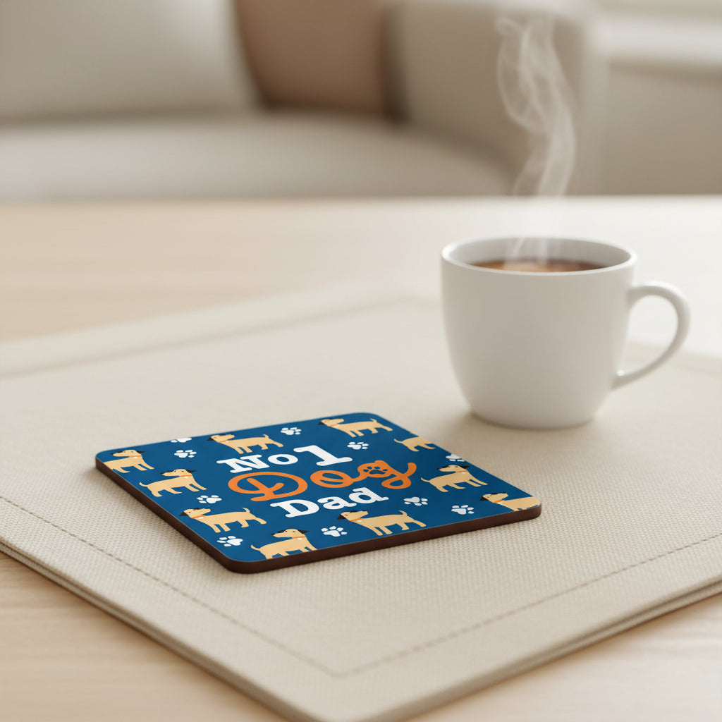 Square graphic with rounded corners featuring the phrase 'No 1 Dog Dad' on a dark blue background, surrounded by repeated cartoon dogs and white paw prints.