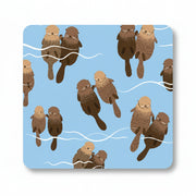 Pale blue coaster with pairs of otters floating and holding paws