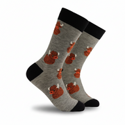 Grey socks printed with Highland coos and rubber ducks on a white background