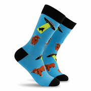 Bright blue socks with UFOs abducting Highland cows on a white background