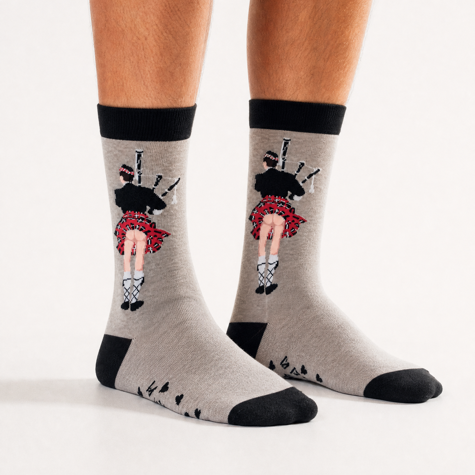 Grey kilt bum socks worn, with the piper design facing forward