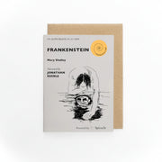 Frankenstein Audiobook in a Card, pale grey card with a black line drawing of the creature and kraft envelope