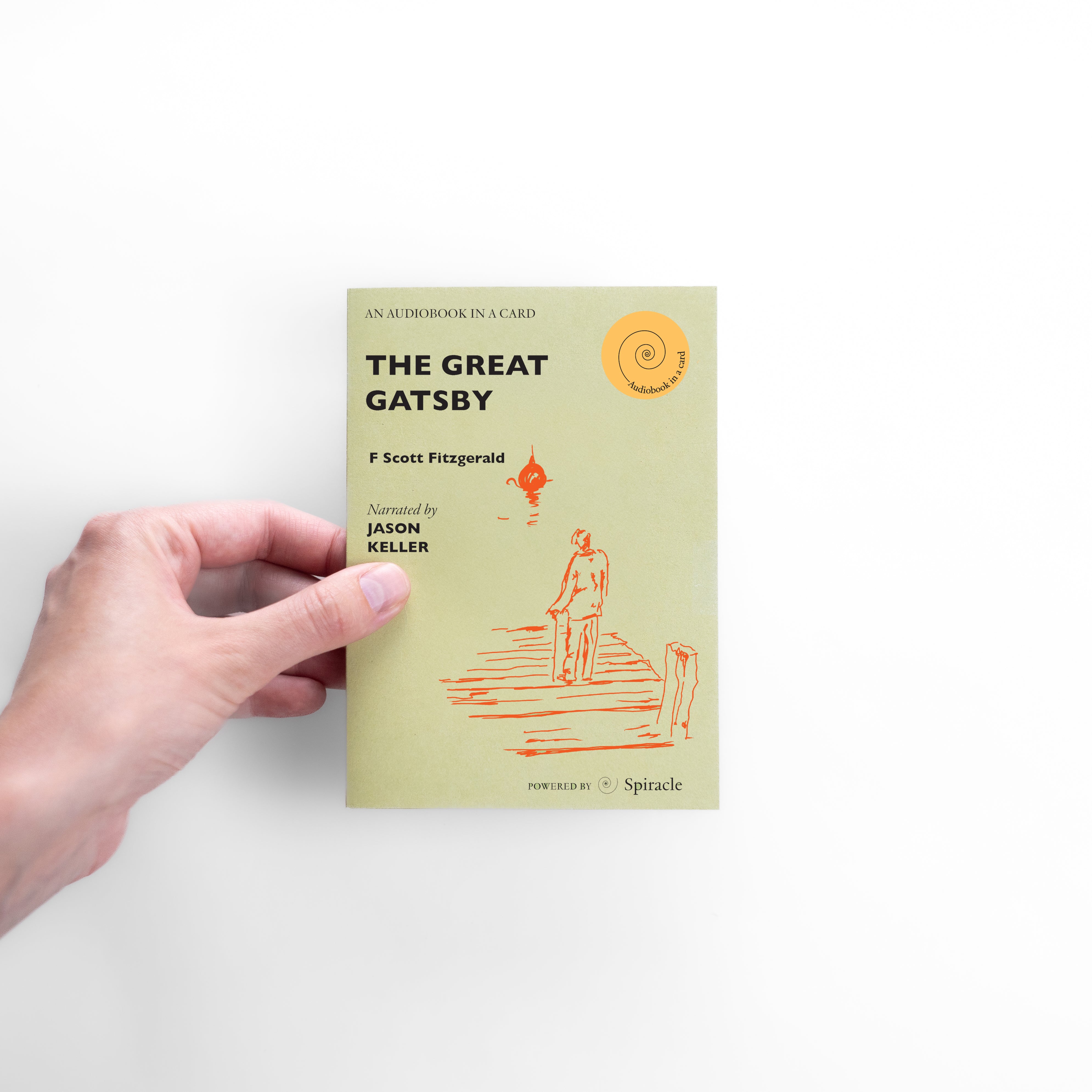 Hand holding The Great Gatsby audiobook card to show its size