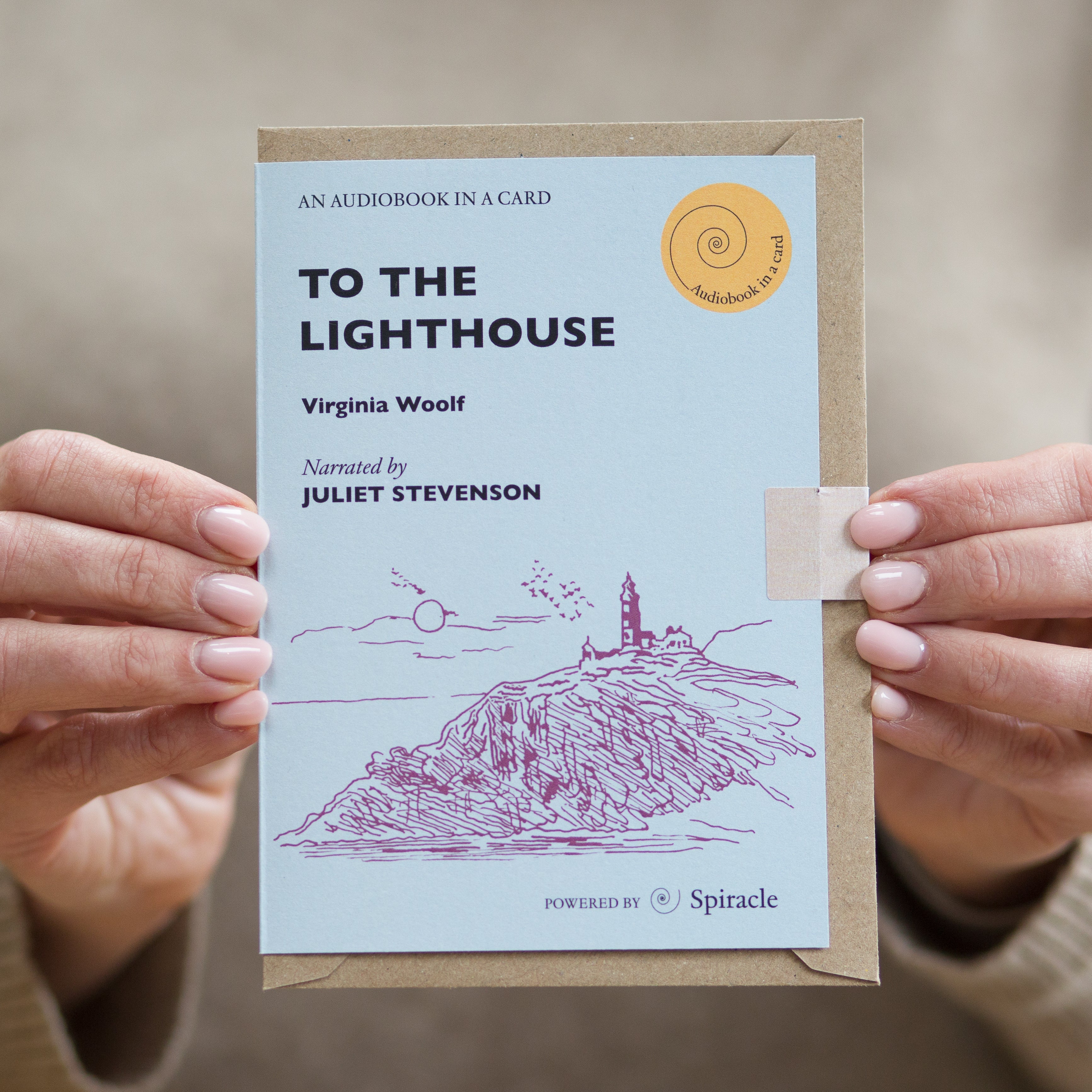 Hand holding the To the Lighthouse audiobook card to show its size