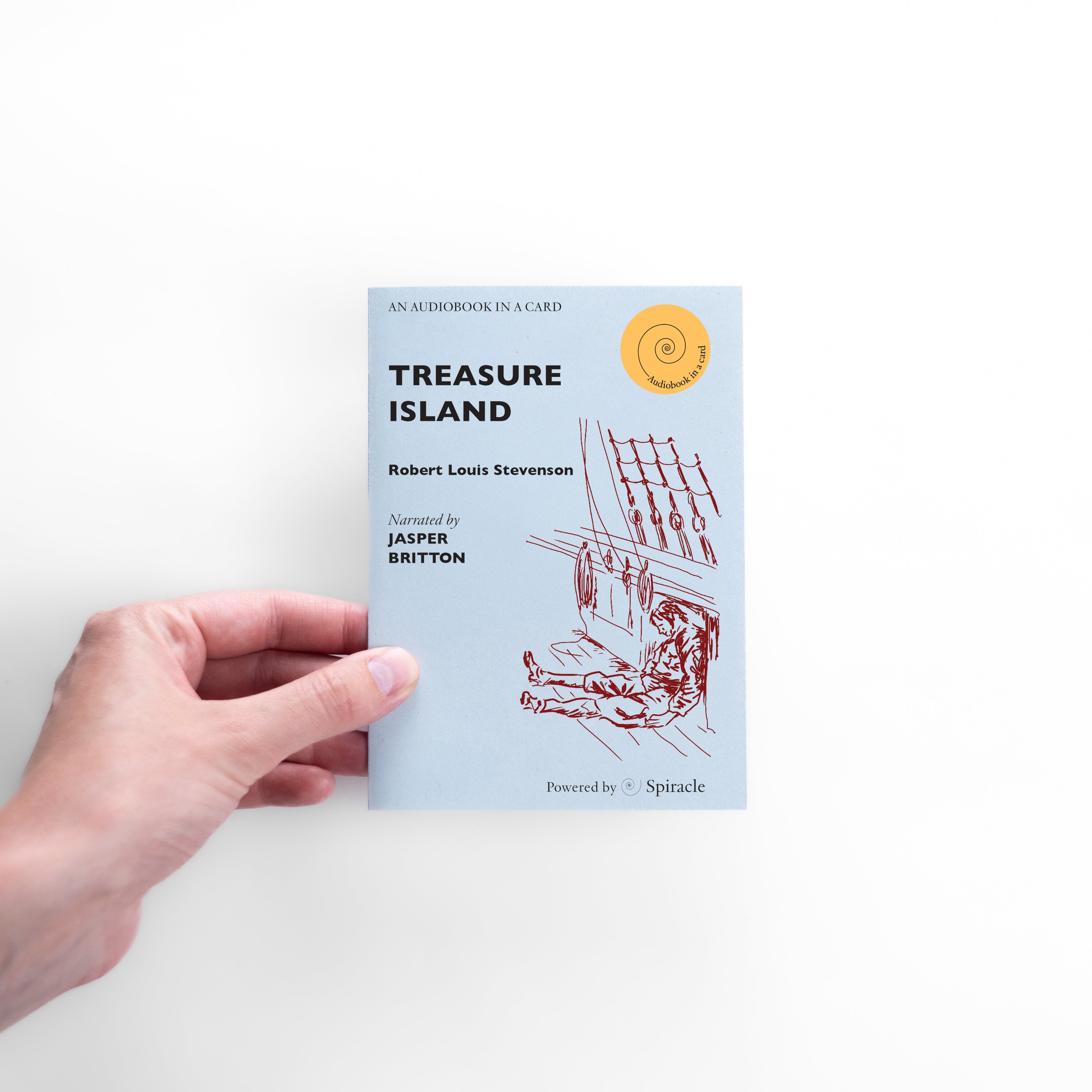 Hand holding the Treasure Island audiobook card to show its size