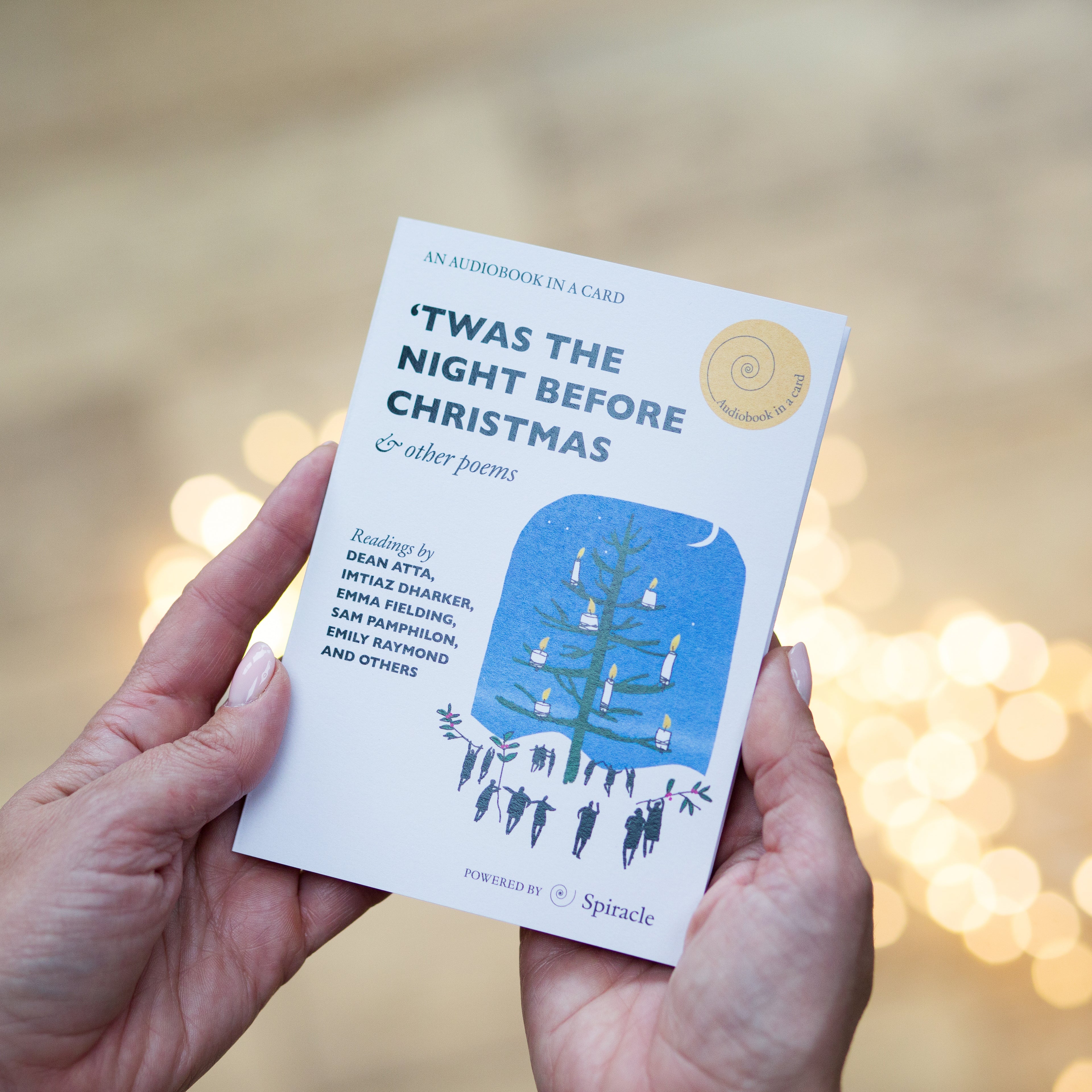 Hand holding the Christmas audiobook card to show its size