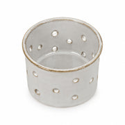 Glazed Ceramic Tealight Holder with pierced dots on a cream background