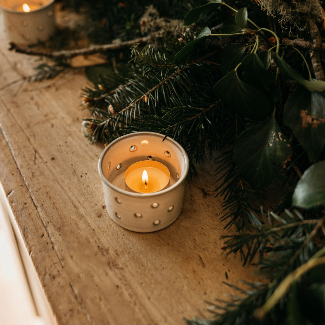 Orange & Cinnamon Christmas tealight lit and glowing in a holder