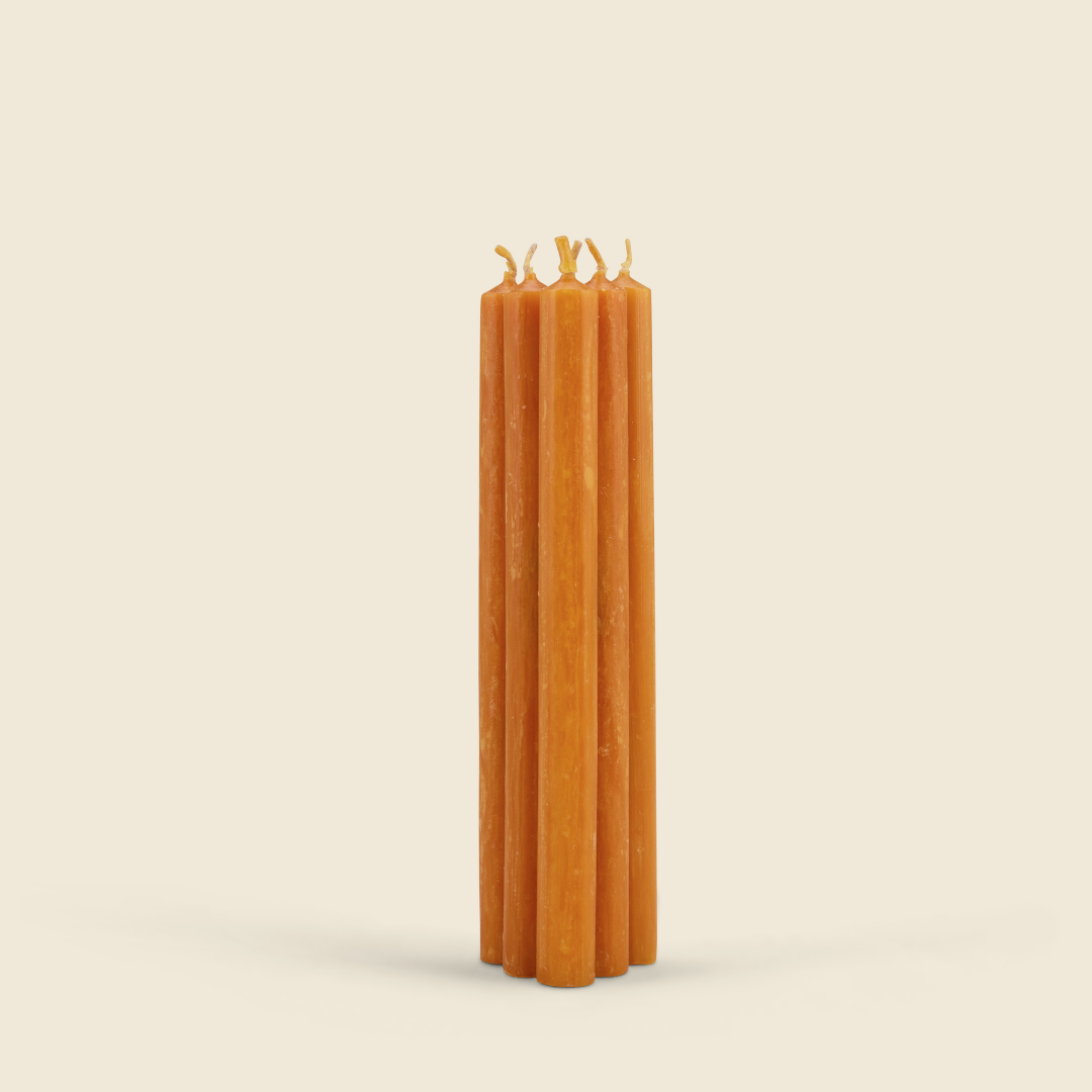 Orange & Cinnamon Mini Festive Candles, Pack of 6 bundle of six orange candles on a cream background