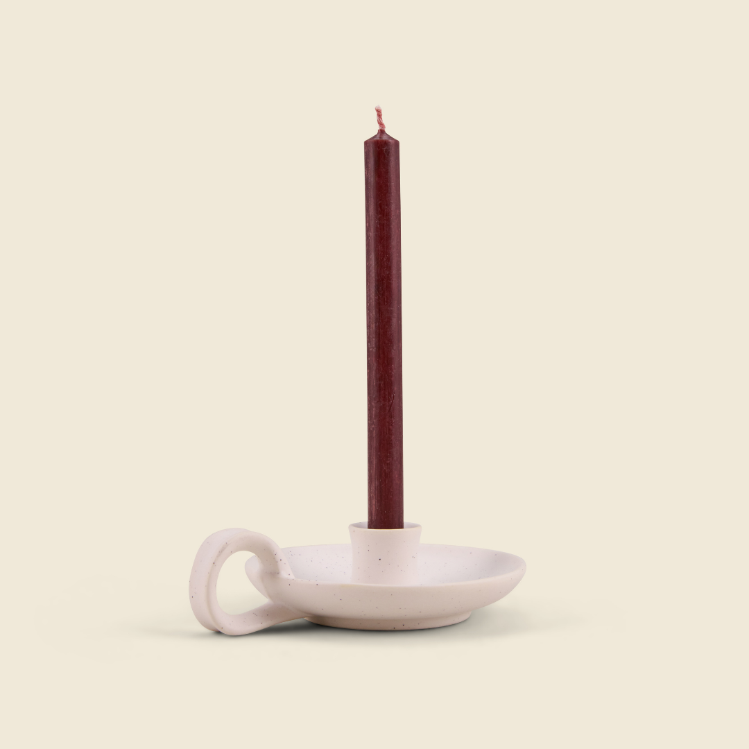 Sacred Forest mini deep red candle in a white speckle holder, cream background