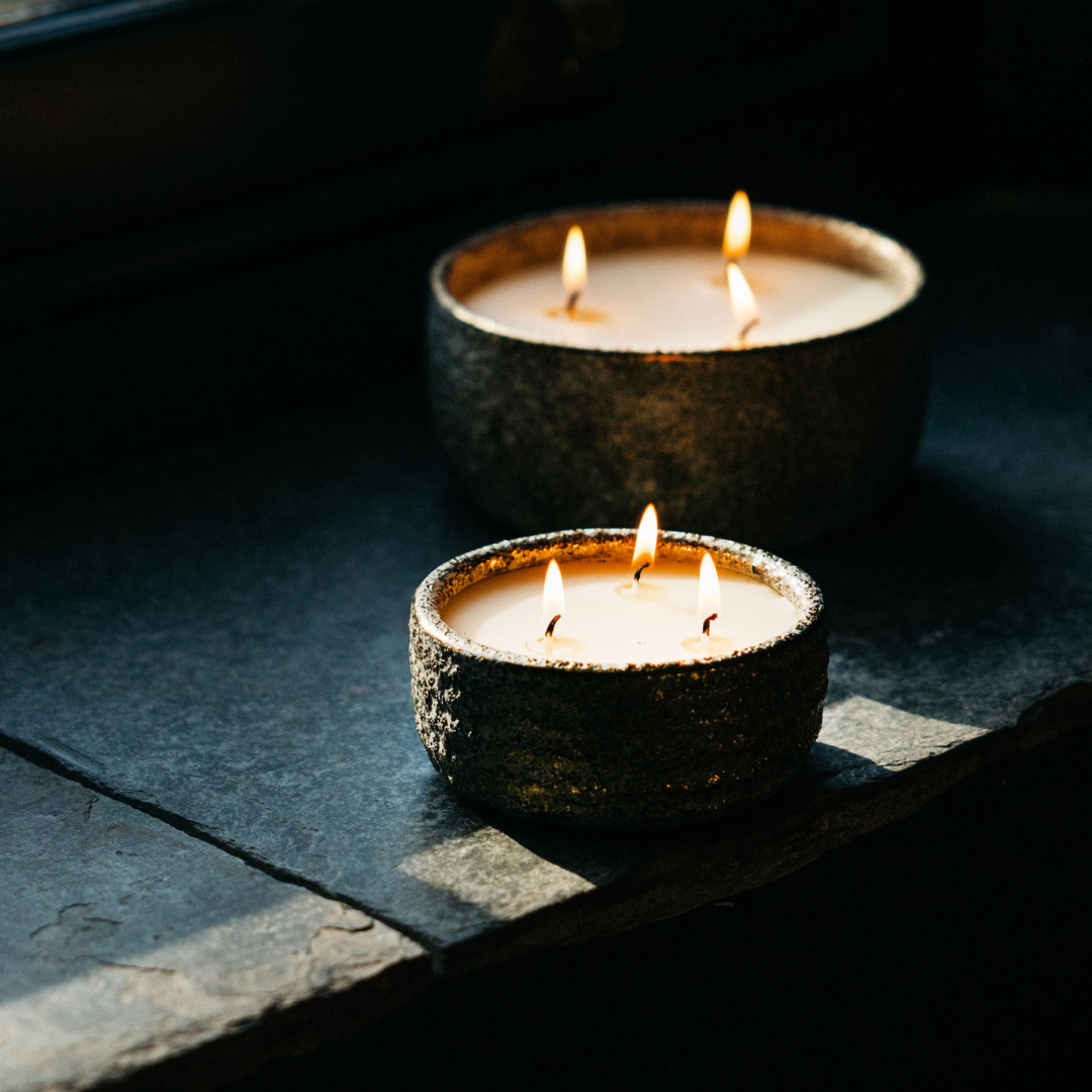 Sacred Forest Small Alchemy Pot Candle lit with three flames in a cosy festive setting