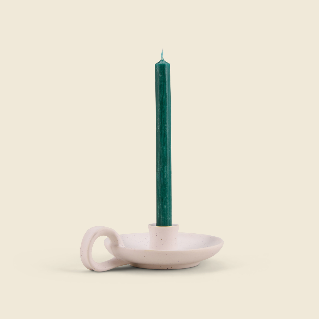 Winter Thyme mini green candle in a white speckle holder, cream background
