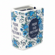 Ceramic book candle showing spine and front cover with blue floral pattern