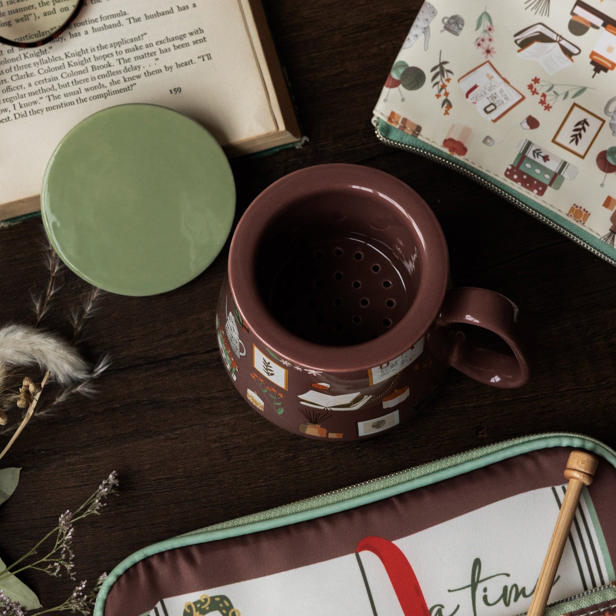 Tea infuser mug from above with the strainer inside on dark wood