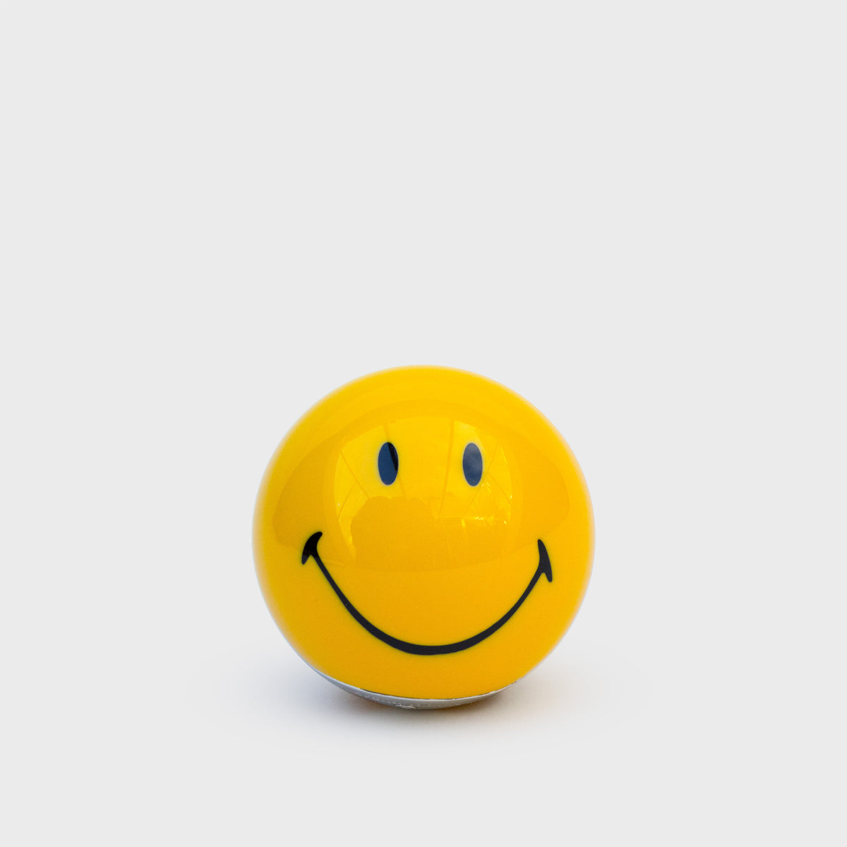 Yellow Smiley face pool ball bottle opener seen from the front
