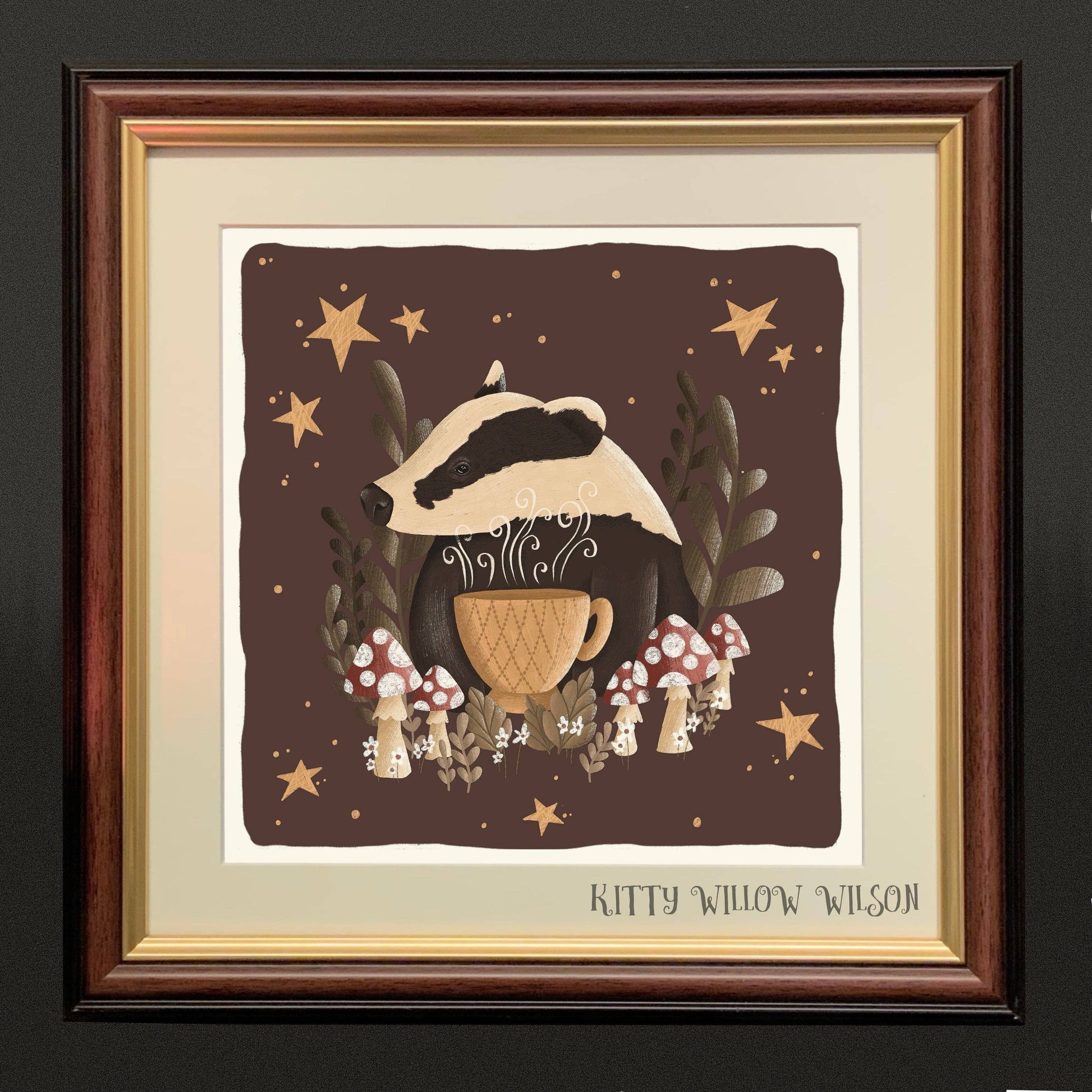 Art print of a badger peering over a teacup among toadstools and stars, shown framed