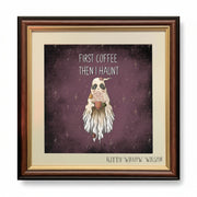 Framed art print featuring a ghost-like coffee cup character on a dark purple starry background with the text 'FIRST COFFEE THEN I HAUNT' and 'KITTY WILLOW WILSON' at the bottom.