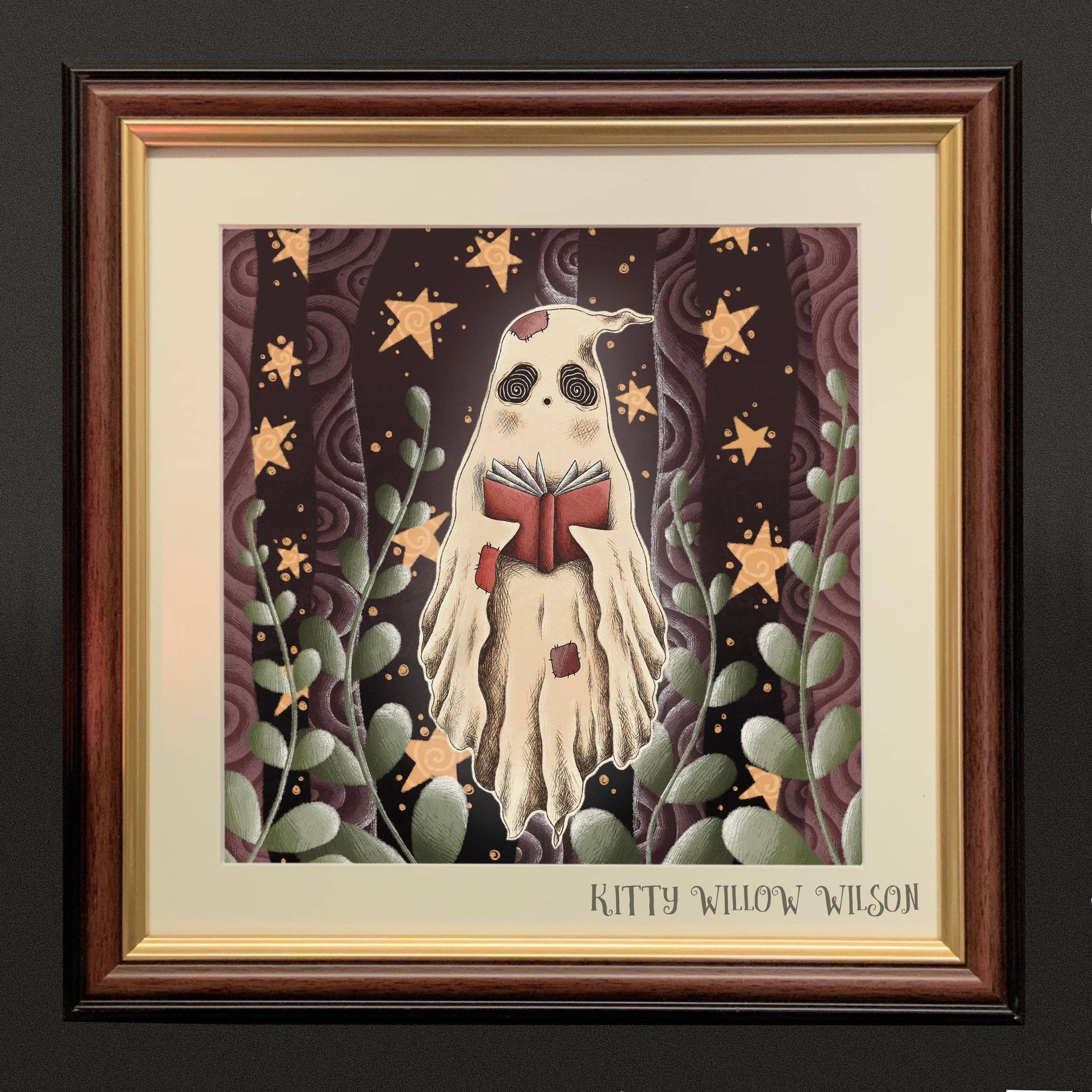 Art print of a ghost reading a red storybook among gold stars, shown framed