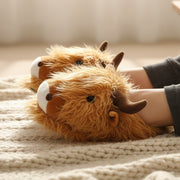 Ladies novelty slippers in the shape of a Scottish Highland Cow. 